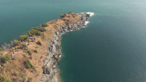 View-of-Promthep-Cape,-southern-most-tip-of-Phuket,-Thailand---Aerial-Tilt-up-Reveal-shot