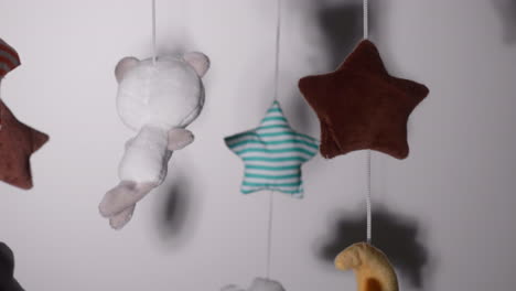 Woven-Toys-Hanging-On-Crib-Mobile-With-Lullaby-Music-Inside-A-Nursery-Room