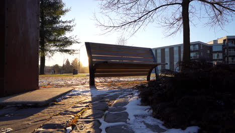 Pan-shot-of-a-benchpark-in-winter-by-sunset