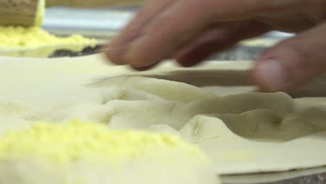 Man-kneading-pizza-dough-by-hand