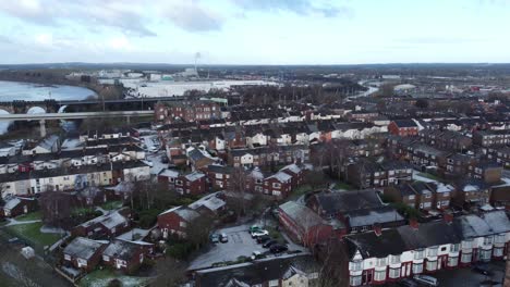 Aerial-rise-above-industrial-small-town-frosty-church-rooftops-neighbourhood-North-West-England