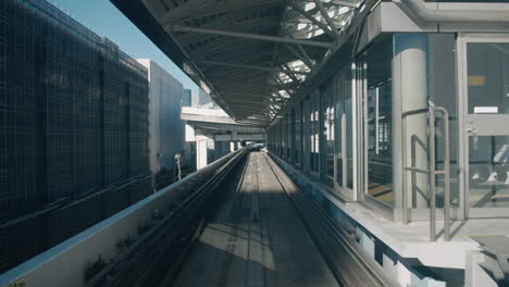 POV-From-Yurikamome-Monorail-Arriving-At-Train-Station-In-Tokyo,-Japan-During-Pandemic