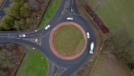 Over-head-drone-shot-of-a-roundabout-being-used-by-cars-and-lorries-in-England