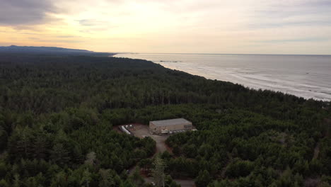 Aerial-View-Of-Telephone-Company-Building-In-The-Midst-Of-Dense-Forest-In-Oregon-Coastline