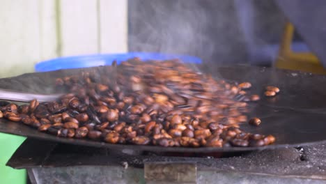 Bunna-seller-is-roasting-the-Coffee-beans-in-her-small-traditional-shop,-in-Addis-Ababa-in-Ethiopia