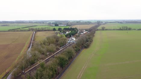 A-drone-reveal-shot-of-a-village-train-station-in-Kent,-England