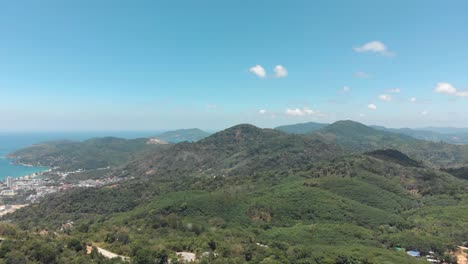 Southern-Phuket-lush-jungle-and-Mountainous-Landscape-surrounded-by-Andaman-Sea-in-Thailand---Aerial-Low-Panoramic-shot