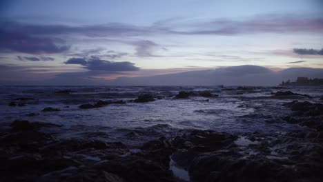Ocean-waves-during-twilight-at-a-rocky-beach