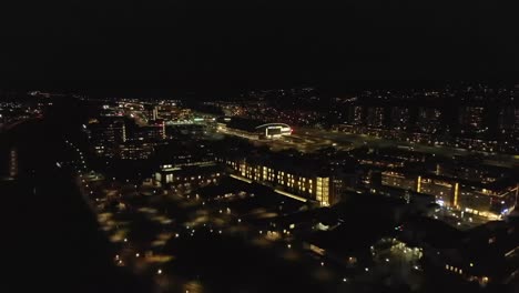 Stunning-night-time-aerial-view-of-downtown-Partille-with-illuminated-skyline,-buildings-and-street-lights-in-Gothenburg-City,-Sweden