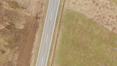 Above-the-road-where-cars-driving,-zoom-in,-Drone-4K