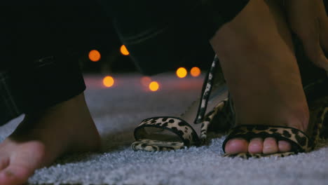 Close-up-of-American-girl-teenager-takes-off-cougar-patterned-shoes-heels-entering-home-on-carpet-feet-toes-walking-away-from-door-toe-nail-painted-cozy-home-relaxing-cold-no-socks-finally-calm-jeans