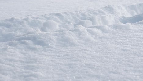 Person's-legs-are-walking-through-deep-snow-in-close-up-shot