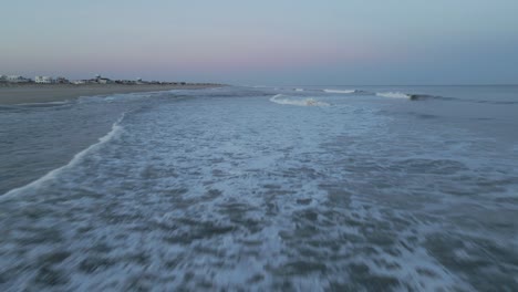 Frothy-Ocean-Waves-Washing-Up-On-Sandy-Shore-During-Sunset-At-Long-Beach-Island-In-New-Jersey,-USA