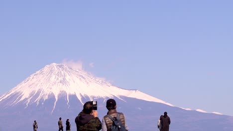 Back-of-people-taking-pictures-of-Mount-Fuji,-showing-the-scale-of-mountain