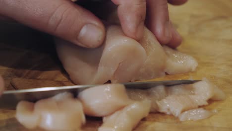Motion-controlled-shot-of-cutting-chicken-meat