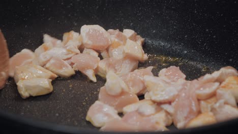 Motion-controlled-slow-motion-shot-of-chicken-meat-in-a-cooking-pan