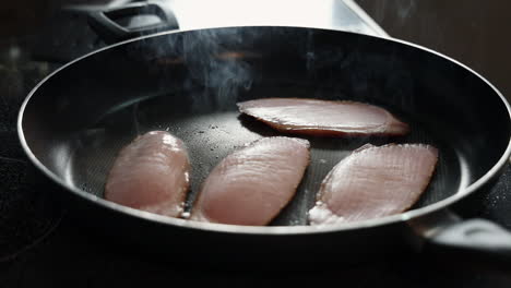 Frying-Slices-Of-Homemade-Bacon-In-A-Skillet