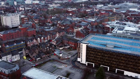 Early-morning-aerial-Warrington-England-city-street-multi-storey-carpark-rooftop-townscape-pan-left