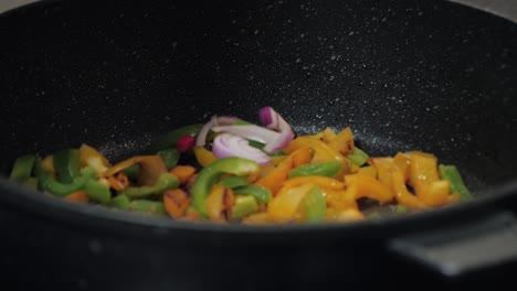 Motion-controlled-slow-motion-shot-of-paprika-in-a-cooking-pan