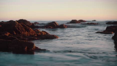 Calm-waves-going-through-the-rocks-in-ultra-slow-motion