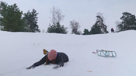 Woman-on-a-sleigh-falling-flat-on-her-face-on-the-snow-in-slow-motion