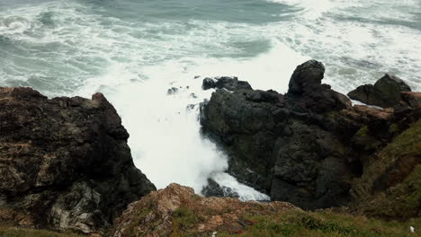 White-Waves-Breaking-Against-Cliff-In-Lighthouse-Beach,-Port-Macquarie,-Australia,-View-From-Above---high-angle-shot