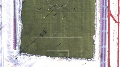Football-club-on-the-winter-preparations-on-the-artificial-grass,-from-the-top-,-Drone-4K