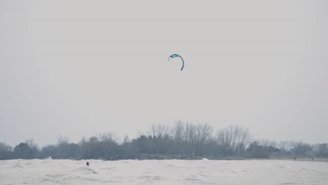 Kitesurfer-Riding-On-Extreme-Sea-Wave-With-Fall-Season-Background