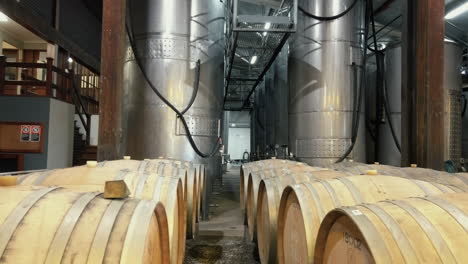 Row-Of-Tanks-And-Barrels-In-Brewery-Warehouse---handheld