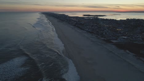 Calm-Waves-With-Offshore-Township-During-Dusk-At-Long-Beach-Island,-Atlantic-Ocean-Coast-In-New-Jersey