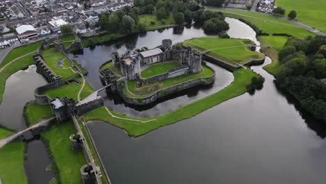 Medieval-castle-surrounded-by-moat-in-Caerphilly,-South-Wales