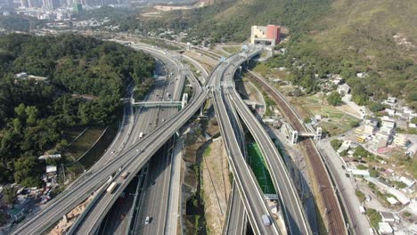 Traffic-on-a-Massive-highway-interchange-with-multiple-levels-and-loop-shaped-road-in-Hong-Kong,-Aerial-view