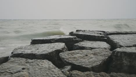 Sea-Waves-Crash-On-The-Breakwater-Rocks-And-Stones-During-Daytime