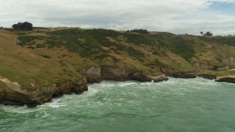 Aerial-shot-of-cliffs-during-the-day-along-the-coastline-in-New-Zealand