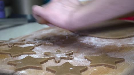 Caucasian-female-working-on-gingerbread-dough-with-a-rolling-pin
