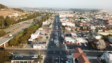 Aerial-static-shot-over-Pismo-city-main-road-and-crossroad,-California