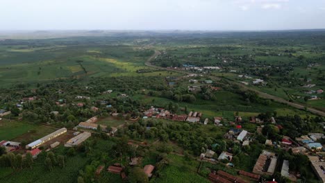 Aerial-view-of-a-town,-on-the-countryside-of-Kenya,-Africa---tracking-drone-shot