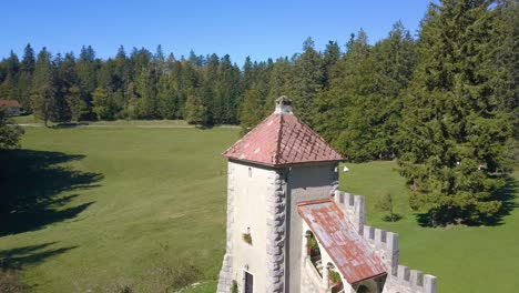 Ancient-Castle-Tower-of-Sneznik-Palace-in-Slovenia,-Aerial-Ascending-View