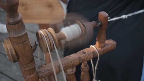 Producing-homespun-wool-yarn-on-a-traditional-wooden-spinning-wheel