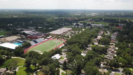 American-High-school-empty-football-field-and-urban-area