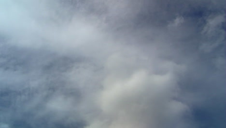 Time-lapsed-shot-of-clouds-at-different-altitudes-moving-in-opposite-directions