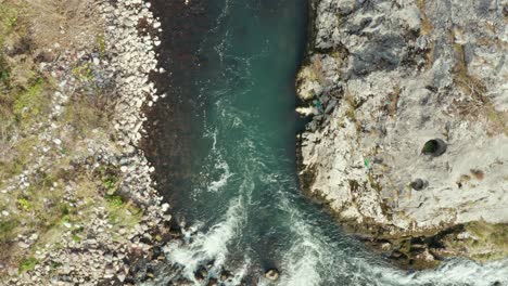 Whitewater-rapids,-fast-river-water-flowing-over-rocks,-aerial-top-down-view