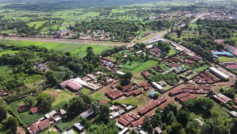 Aerial-View-of-Small-City-in-Green-Landscape-Under-Kilimanjaro-Mountain,-Kenya