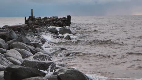 The-sea-wave-washes-away-the-old-abandoned-stone-pier