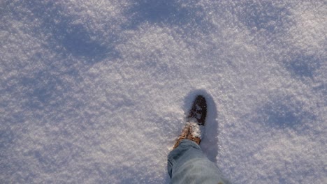 POV-boots-walking-through-thick-fresh-powdery-snow-in-slow-motion-on-a-sunny-winter-day-in-Bavaria,-Germany