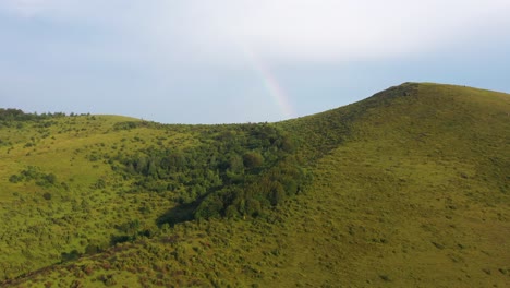 Beautiful-rainbow-rising-above-the-green-hills-of-Pester