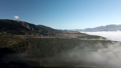 Aerial-view-just-above-the-dense-fog-on-the-valley