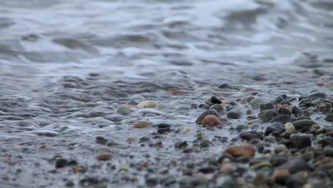 Closeup-Scenery-Of-The-Waves-Crashing-on-the-Black-Stones---Closeup-Shot