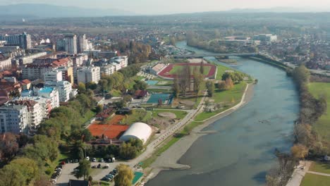 Aerial-dolly-shot-backing-away-from-the-city-of-Kraljevo-in-central-Serbia