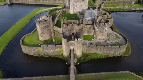 Caerphilly-town,-Wales-landmark-large-medieval-castle,-aerial-view